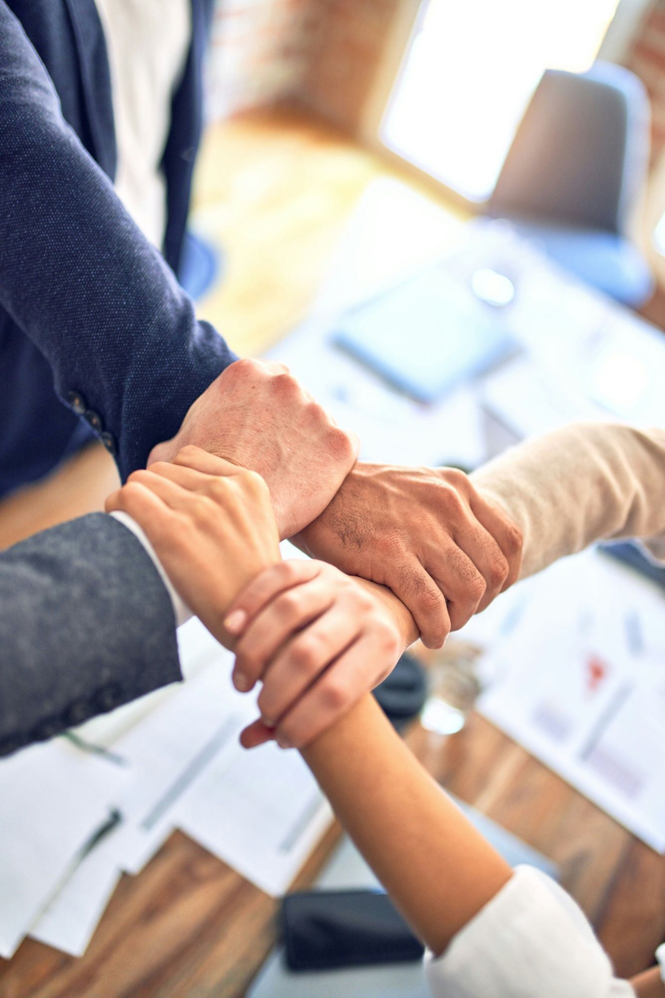 Two people clasping hands over a table